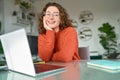 Young happy pretty woman student sitting at home office with laptop. Portrait Royalty Free Stock Photo