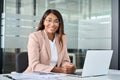 Young happy professional business woman manager sits at office desk, portrait. Royalty Free Stock Photo