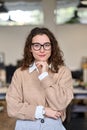 Young happy professional business woman wearing glasses, vertical portrait. Royalty Free Stock Photo