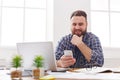 Relaxed young businessman using mobile in office Royalty Free Stock Photo