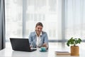 Young happy satisfied successful businesswoman manager and executive sitting in office casually working on laptop computer Royalty Free Stock Photo