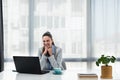 Young happy satisfied successful businesswoman manager and executive sitting in office casually working on laptop computer Royalty Free Stock Photo