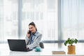 Young happy satisfied successful businesswoman manager and executive sitting in office casually working on laptop computer Royalty Free Stock Photo