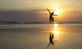 Young happy Asian woman in bikini jumping excited on sunset beach having fun Royalty Free Stock Photo