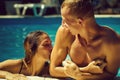 Happy young couple at swimming pool Royalty Free Stock Photo