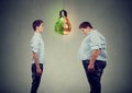 Young happy slim man looking at sad fat guy himself. Diet choice right nutrition concept Royalty Free Stock Photo