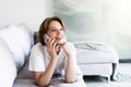 Young happy smile woman phone call on sofa in living room, at home. Excited girl lying talking cellphone Royalty Free Stock Photo