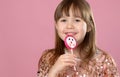 Young happy, smiled, pretty little girl with sweet lollypop candy. Standing in sequined dress Royalty Free Stock Photo