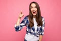 Young happy smiling beautiful brunette woman with sincere emotions wearing trendy check shirt isolated on pink Royalty Free Stock Photo