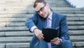 Young happy smiling business man working with tablet, horizontal portrait. Royalty Free Stock Photo