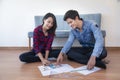 Young happy smiling couple choosing colors for painting their home, Royalty Free Stock Photo