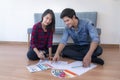 Young happy smiling couple choosing colors for painting their home