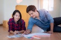 Young happy smiling couple choosing colors for painting their home Royalty Free Stock Photo