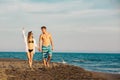 Smiling couple holding hands walking on beach Royalty Free Stock Photo