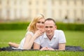 Young, happy and smiling couple lies on a grass Royalty Free Stock Photo