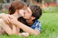 Young happy smiling couple lying outdoors and kiss Royalty Free Stock Photo