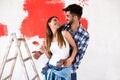 Young happy couple painting walls in their new house Royalty Free Stock Photo