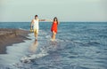 Young happy smiling couple walking on beach Royalty Free Stock Photo