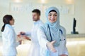 Young happy smiling female muslim doctor giving hand for handshaking Royalty Free Stock Photo