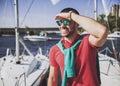 Young Happy Smiling Man in Glasses in Yacht Club.