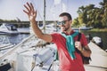 Young Happy Smiling Man in Glasses in Yacht Club. Royalty Free Stock Photo
