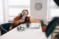 Young happy smiling pretty woman sitting on a chair holding smartphone using cell phone mobile technology looking at a mobile Royalty Free Stock Photo