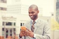 Young happy smiling urban professional man using smart phone outdoors Royalty Free Stock Photo