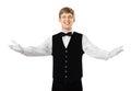Young happy smiling waiter gesturing welcome