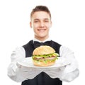 Young happy smiling waiter holding hamburger on plate Royalty Free Stock Photo