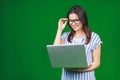 Young happy smiling woman in casual clothes holding laptop and sending email to her best friend Royalty Free Stock Photo