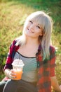 Young happy smiling woman drinking orange juice Royalty Free Stock Photo