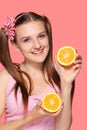 Young happy smiling woman holding half of orange Royalty Free Stock Photo