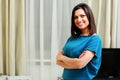 Young happy smiling woman standing with arms folded Royalty Free Stock Photo