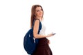 Young happy student girl with blue backpack posing isolated on white background in studio Royalty Free Stock Photo