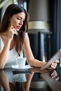 Young happy successful business woman working with tablet in corporate office during coffee break Royalty Free Stock Photo