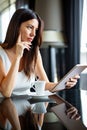 Young happy successful business woman working with tablet in corporate office during coffee break Royalty Free Stock Photo