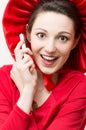 Young happy surprised woman in red with mobile phone Royalty Free Stock Photo