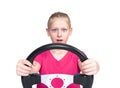 Young happy teenage girl in a pink t-shirt holding a car steering wheel in her hands, front view, isolated on white background. Royalty Free Stock Photo