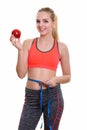 Young happy teenage girl smiling while holding red apple and mea Royalty Free Stock Photo