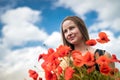 Young happy ukrainian woman holding bouquet of poppies flowers walking, enjoy sunny day in field Royalty Free Stock Photo