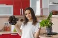 Young happy vegetarian nutritionist woman holds two types of salad in her hands, natural organic food, healthy food at home