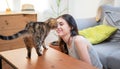Young happy wirl play with cat in room. Royalty Free Stock Photo