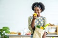 Young happy woman african american afro hair have just returned from the market. and took the tomato, lemon out of the paper bag Royalty Free Stock Photo