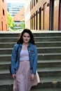 Young happy woman against the background of the stairs Royalty Free Stock Photo