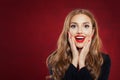 Young happy woman against red wall background. Surprised girl portrait. Positive emotions, facial expression Royalty Free Stock Photo