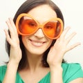 Young happy woman with big orange sunglasses Royalty Free Stock Photo