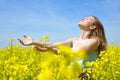 Young happy woman on blooming rapeseed field Royalty Free Stock Photo