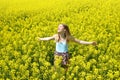 Young happy woman on blooming rapeseed field Royalty Free Stock Photo