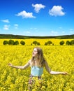 Young happy woman on blooming rapeseed field Royalty Free Stock Photo