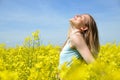 Young happy woman on blooming rapeseed field Royalty Free Stock Photo